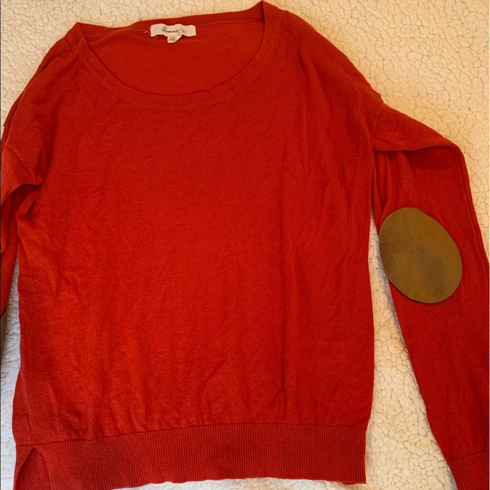 Red-orange sweater with elbow patches